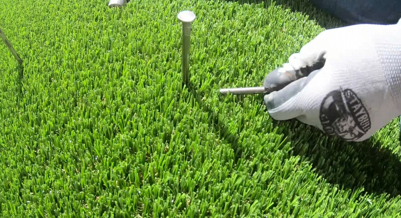 Close-up of expert artificial grass installation technique